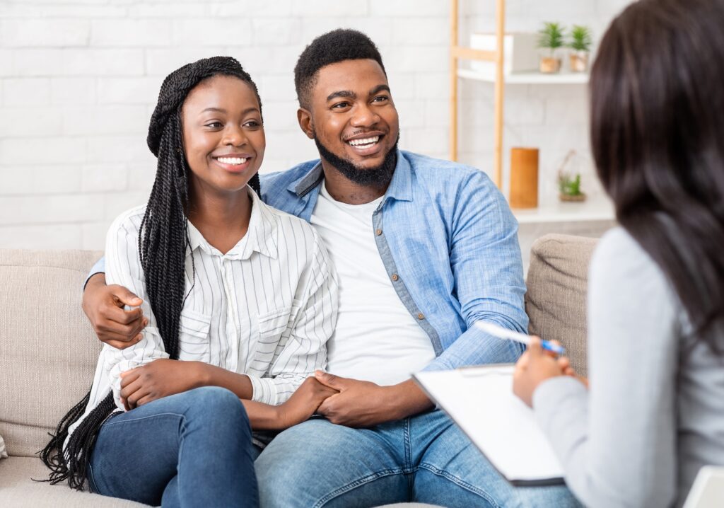 Counselor and happy african american couple after successful marital therapy
